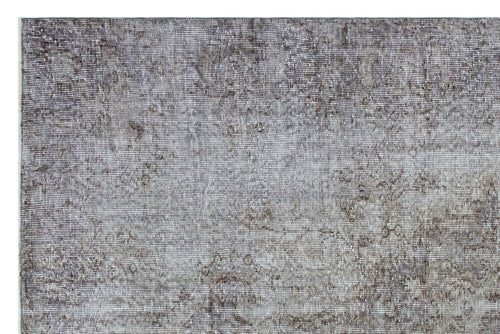 Load image 1 in gallery view. Grey and taupe distressed rug with a faded traditional medallion pattern.