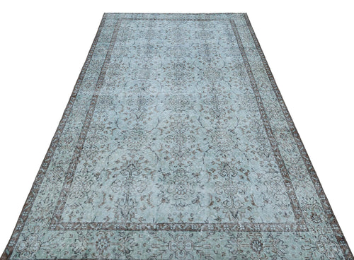 Load image 1 in gallery view. Light blue and dark brown distressed rug with a traditional floral medallion pattern and a wide decorative border.