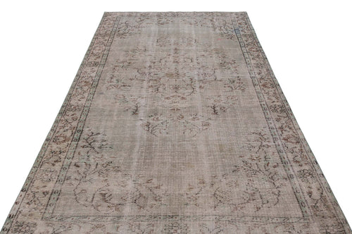 Load image 1 in gallery view. Distressed beige and grey vintage-style rug with a faded central medallion and ornate border on a white background.