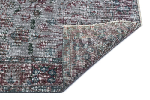 Load image 1 in gallery view. Distressed grey, burgundy, and teal traditional floral rug with a folded corner showing the reverse side.