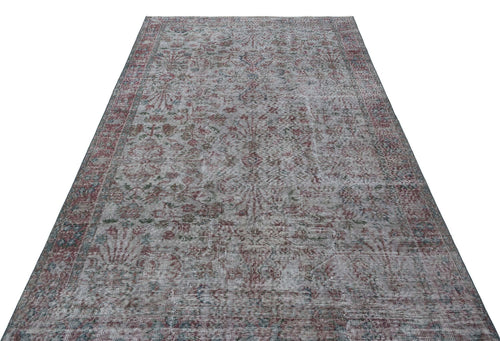 Load image 1 in gallery view. Grey, red, and blue distressed traditional rug with a faded floral medallion pattern on a white background.