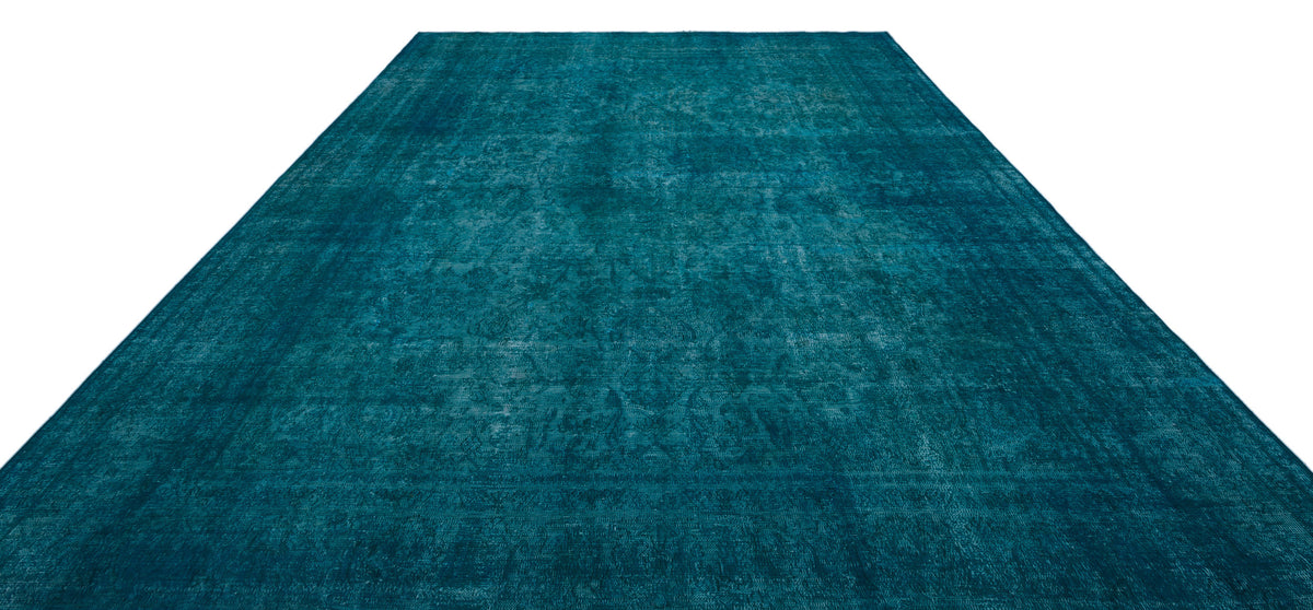 Teal monochromatic rug with a distressed, faded traditional medallion pattern.