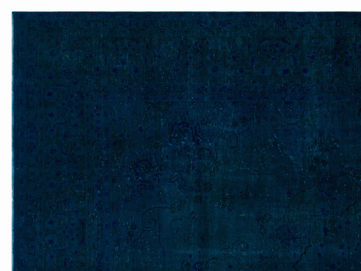 Deep navy blue rug with a subtle, tonal traditional floral pattern and a decorative border.