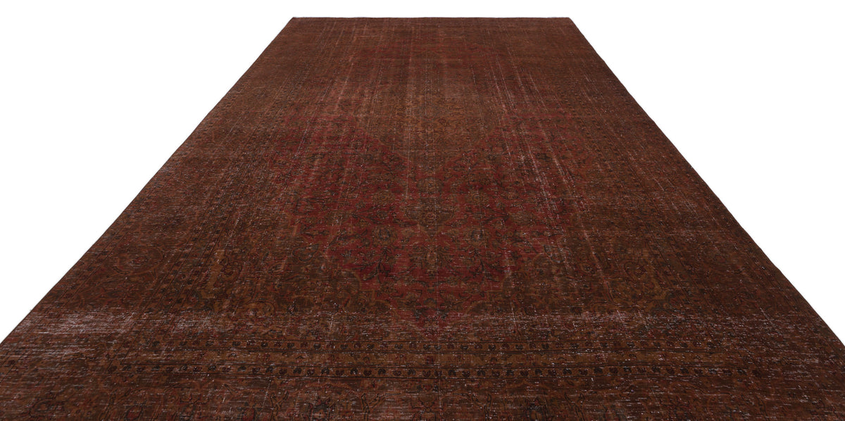 Distressed dark red and brown traditional Persian-style rug with a central medallion and ornate border.
