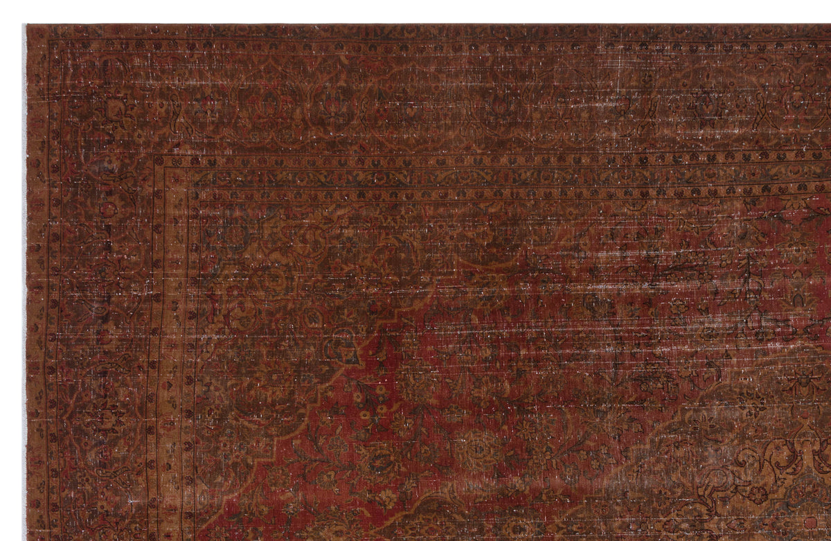 Distressed dark red and brown traditional rug with an intricate floral medallion pattern and a wide decorative border.