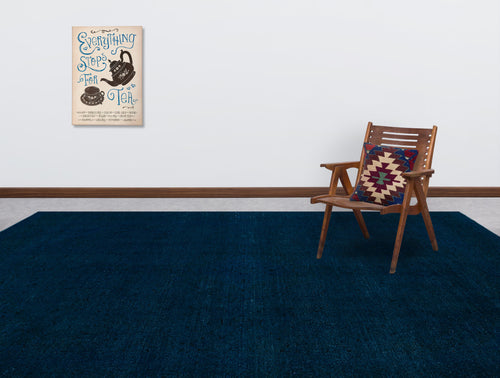 Load image 1 in gallery view. Solid navy blue rug in a room with a wooden chair and wall art.