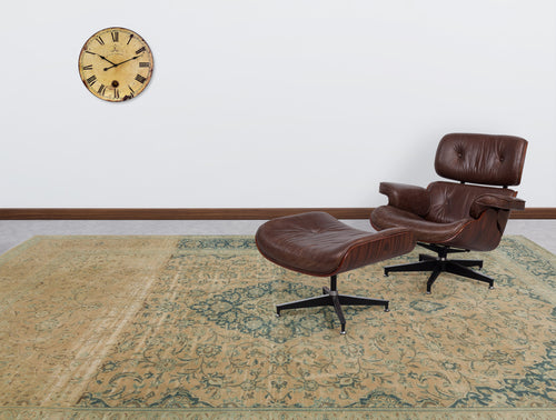 Load image 1 in gallery view. Tan and teal distressed traditional medallion rug in a room with a leather lounge chair and wall clock.
