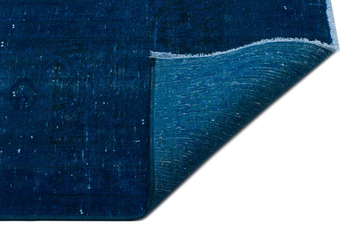 Load image 1 in gallery view. Deep blue distressed rug with a folded corner revealing a lighter teal backing and fringed edge on a white background.