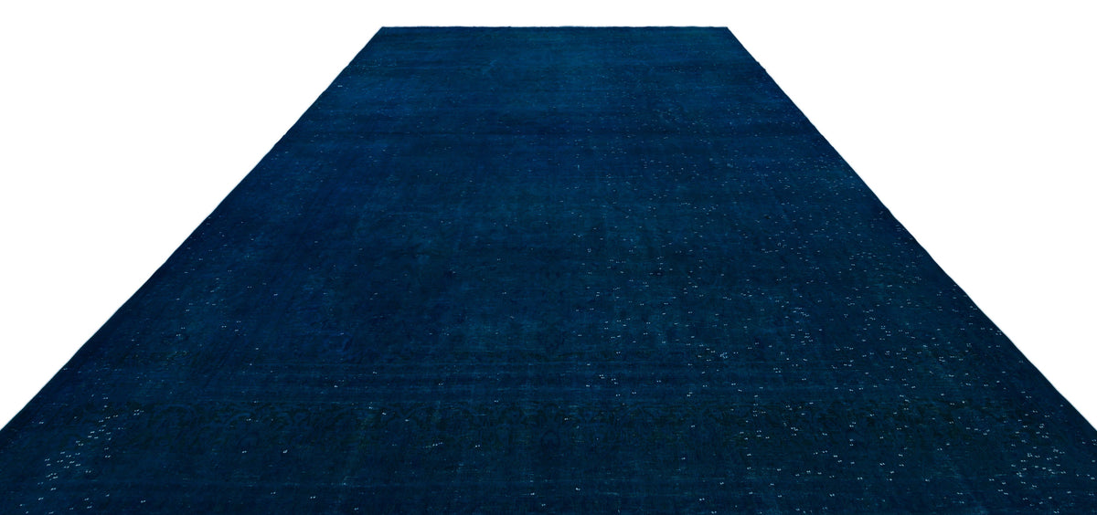 Solid deep blue vintage-style rug with a subtle, distressed tonal pattern and faint border detail on a white background.