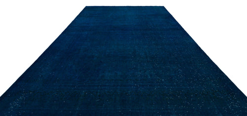 Load image 1 in gallery view. Solid deep blue vintage-style rug with a subtle, distressed tonal pattern and faint border detail on a white background.