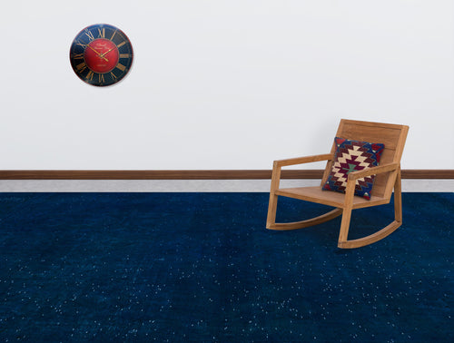 Load image 1 in gallery view. Solid navy blue rug with subtle white speckles, styled in a room with a wooden rocking chair and wall clock.