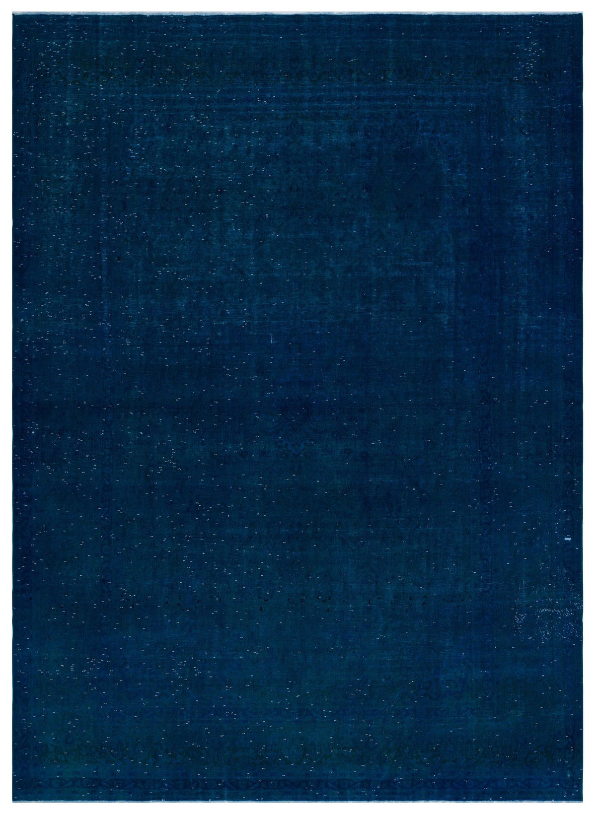 Deep navy blue rug with a subtle, distressed traditional medallion pattern and white speckled accents.