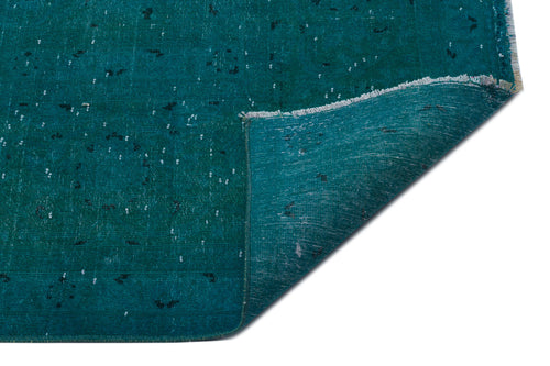 Load image 1 in gallery view. Teal distressed rug with a white speckled pattern and a folded corner showing the woven backing on a white background.
