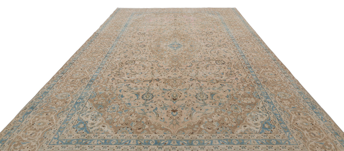 Beige and light blue traditional Persian-style rug with a central floral medallion and intricate border pattern.