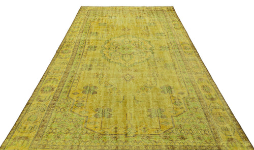 Load image 1 in gallery view. Yellow distressed vintage-style rug with a faded central medallion and ornate border pattern on a white background.