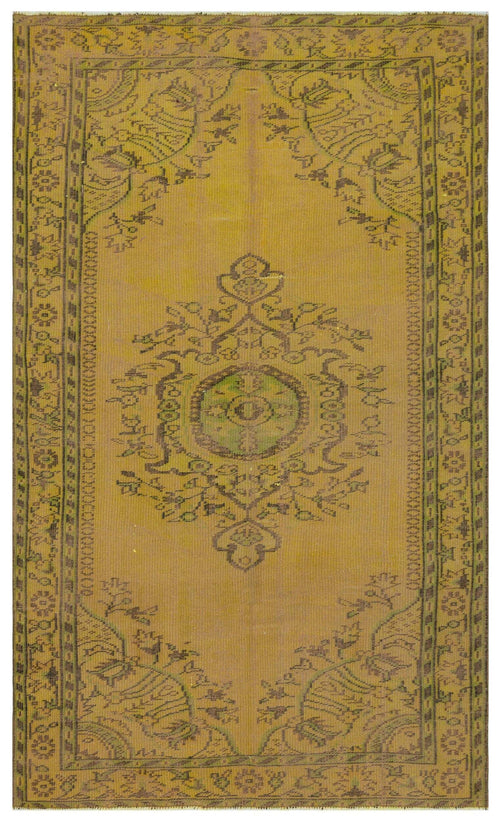 Load image 1 in gallery view. Mustard yellow vintage-style rug with a central floral medallion and a geometric border in dark brown and green.