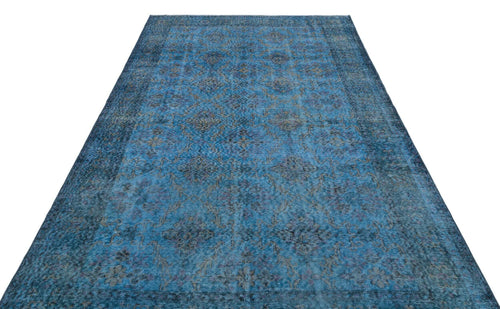 Load image 1 in gallery view. Blue distressed traditional rug with a faded floral medallion pattern on a white background.