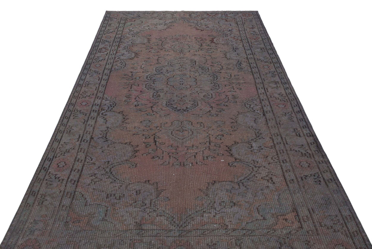 Distressed dark red and charcoal grey traditional rug with a central floral medallion and ornate border.
