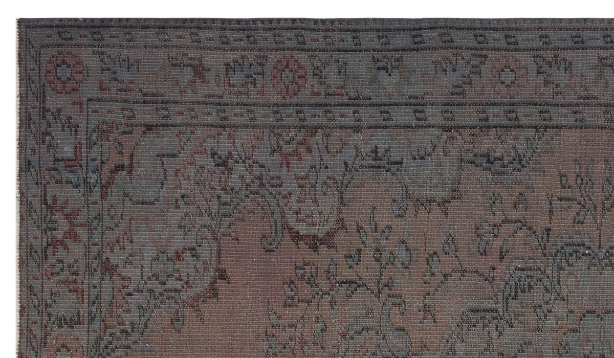 Charcoal and muted red traditional rug with a distressed floral medallion pattern and a geometric border.