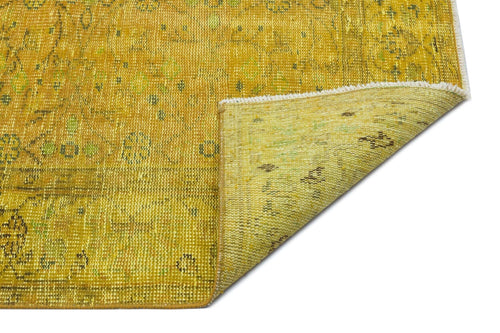 Load image 1 in gallery view. Mustard yellow and green distressed traditional rug with a folded corner showing the woven backing.