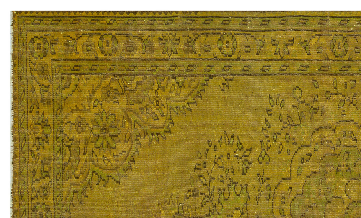 Olive green vintage-style rug with a dark brown traditional floral medallion border and intricate botanical motifs.