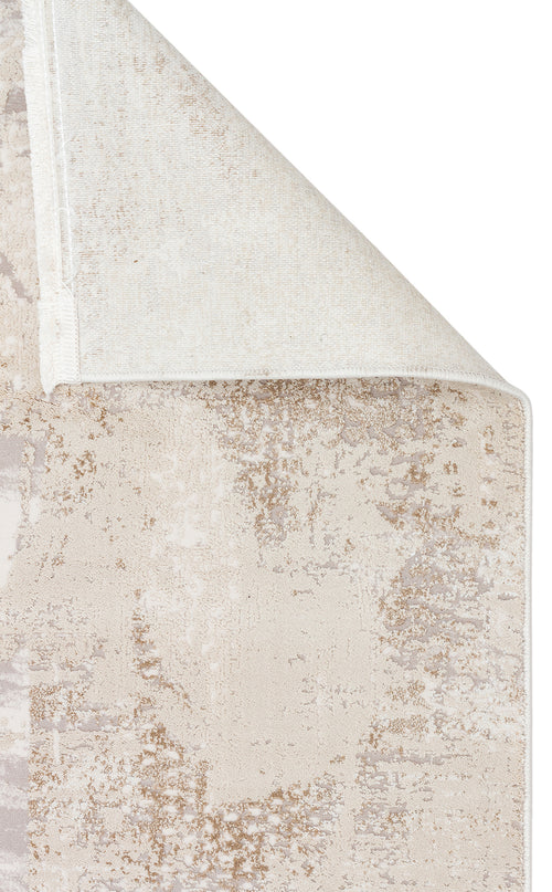 Bild 1 in Galerieansicht laden. Beige and cream rug with a distressed abstract pattern, shown with a corner folded over to reveal the woven backing.