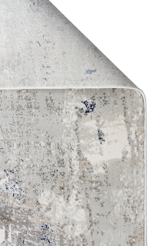 Load image 1 in gallery view. Grey, white, and navy blue abstract distressed rug with a folded corner showing the woven backing on a white background.