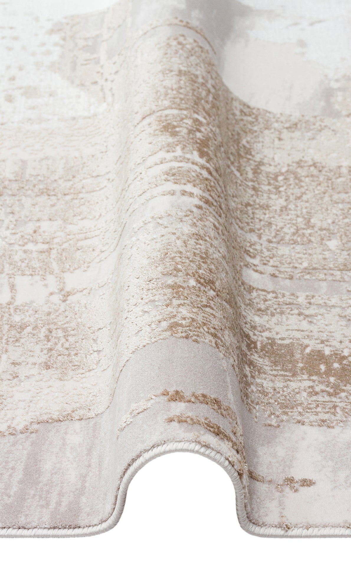 Beige and cream area rug with a distressed, abstract textured pattern, shown folded on a white background.
