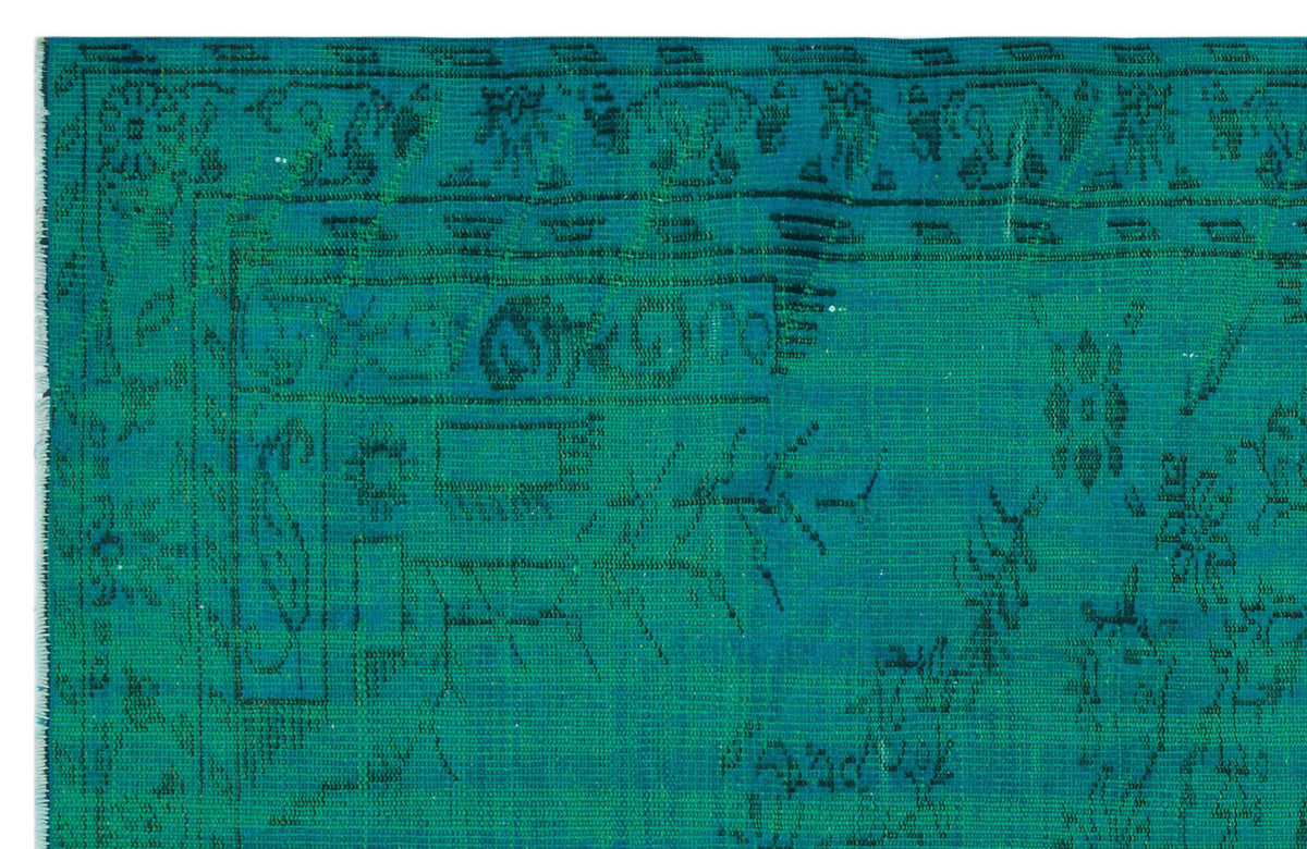 Teal rug with a distressed, faded black traditional floral and geometric border pattern.