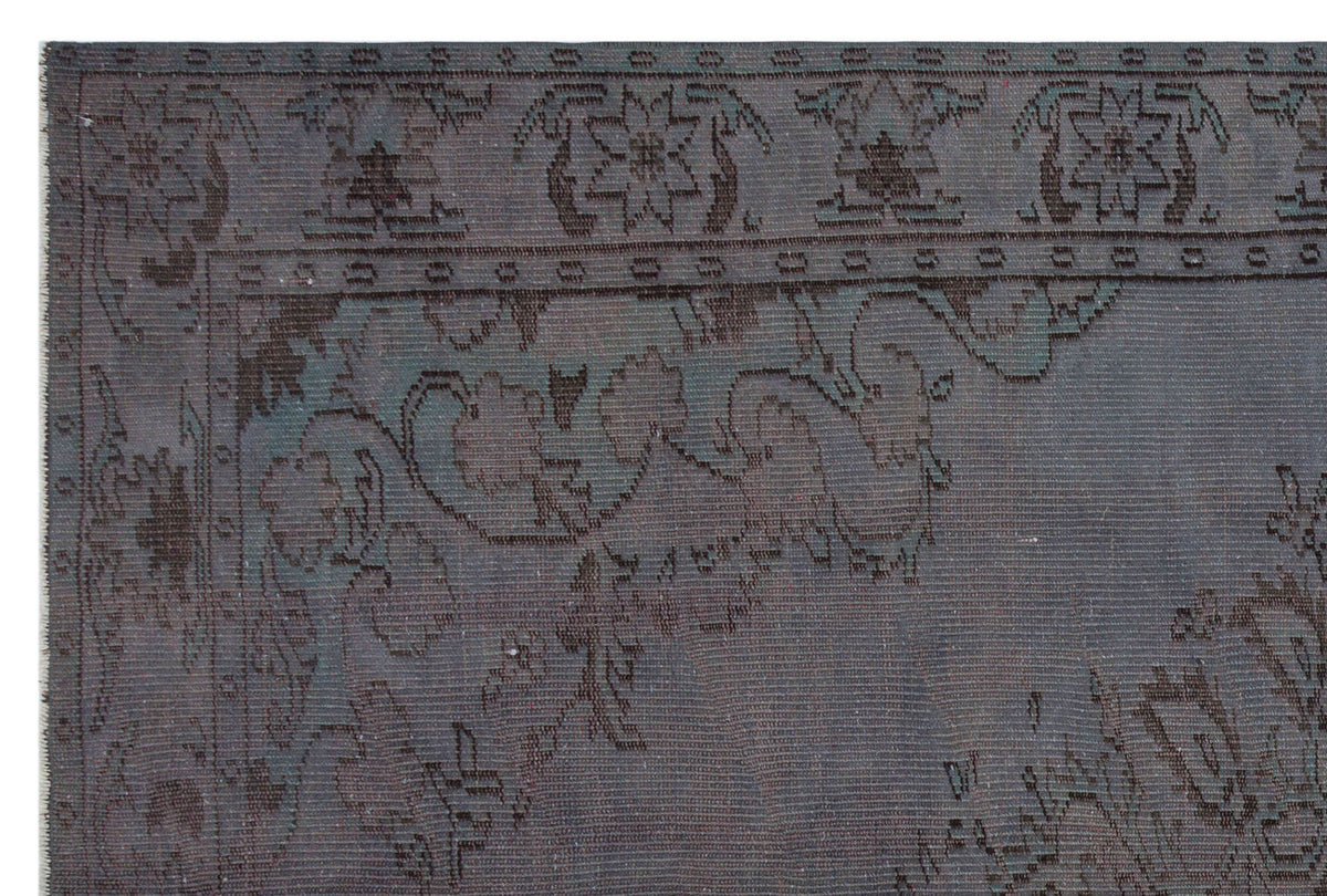 Charcoal and slate grey traditional rug with a distressed floral border and medallion pattern.
