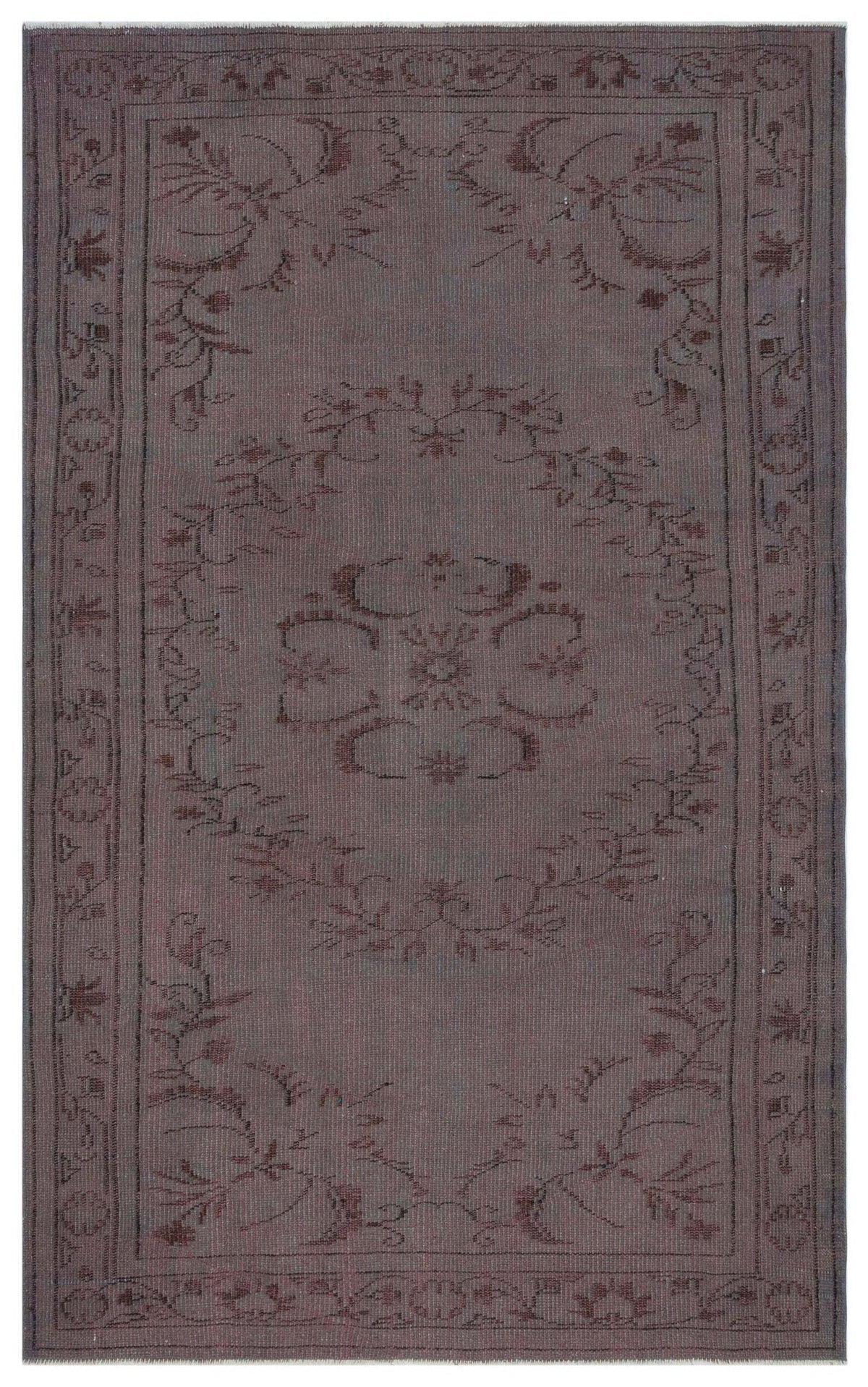 Dark brown monochromatic rug with a central floral medallion and a decorative border on a white background.