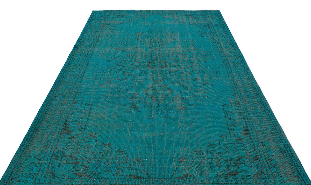 Teal and charcoal distressed traditional rug with a central medallion pattern on a white background.