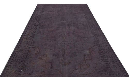 Load image 1 in gallery view. Dark charcoal overdyed vintage rug with a faint, traditional Persian-style medallion pattern on a white background.