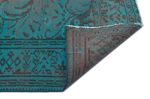Load image 1 in gallery view. Teal and charcoal distressed traditional rug with a folded corner revealing the reverse side on a white background.