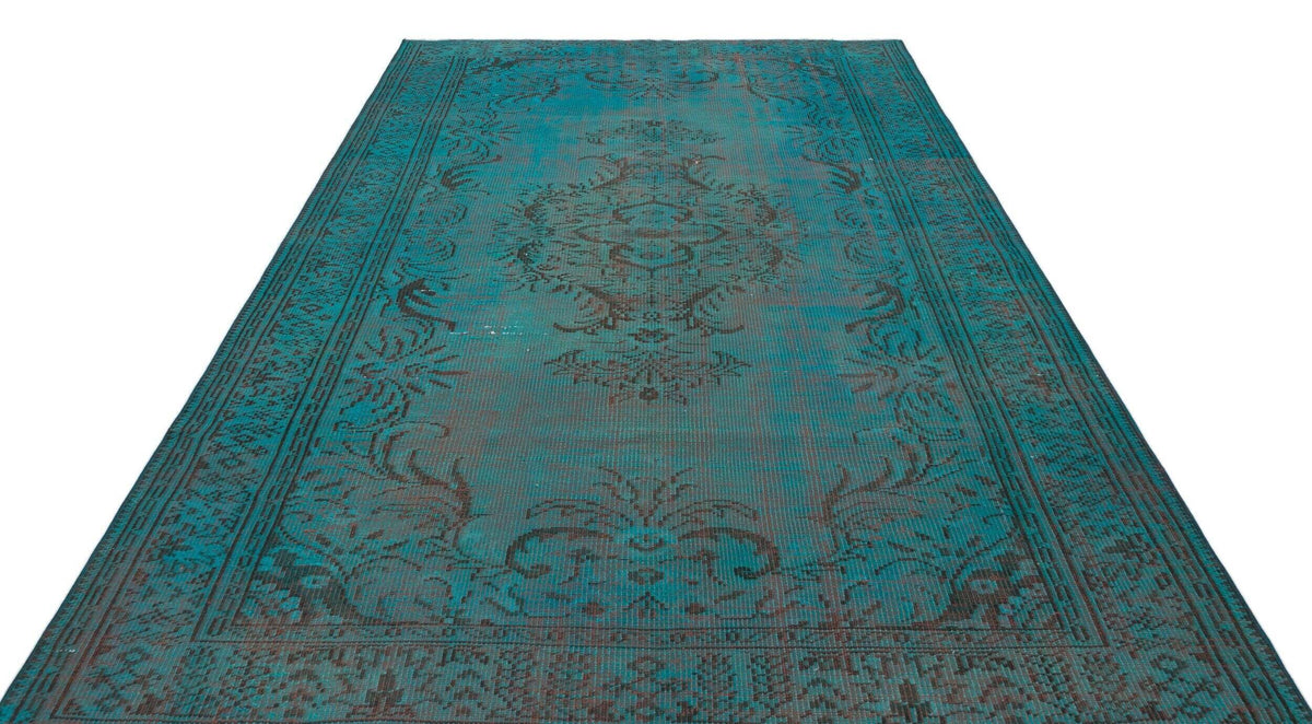 Teal and dark brown distressed rug with a traditional central medallion and ornate border pattern on a white background.