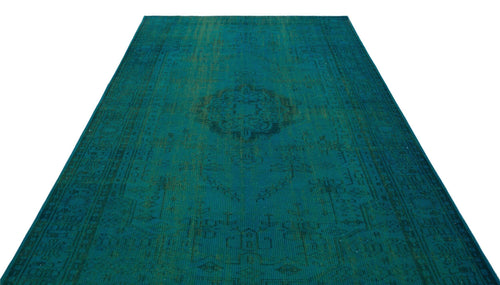Load image 1 in gallery view. Teal distressed overdyed rug with a faint traditional medallion pattern on a white background.