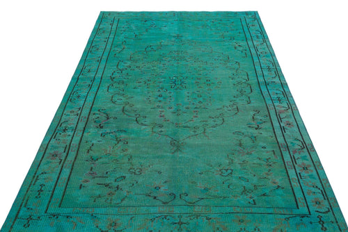 Load image 1 in gallery view. Teal vintage-style rug with a dark, distressed central medallion and geometric border on a white background.