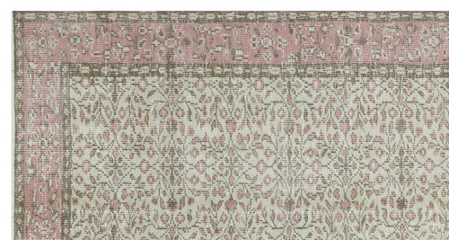 Load image 1 in gallery view. Distressed pink, beige, and taupe rug with a traditional floral medallion border and intricate botanical pattern.