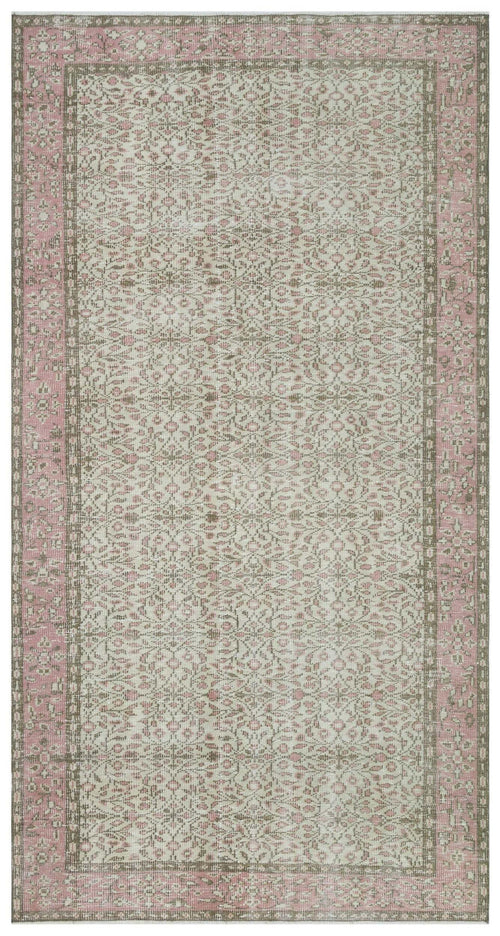 Load image 1 in gallery view. Distressed beige and pink rug with a traditional floral medallion pattern and a wide decorative border.