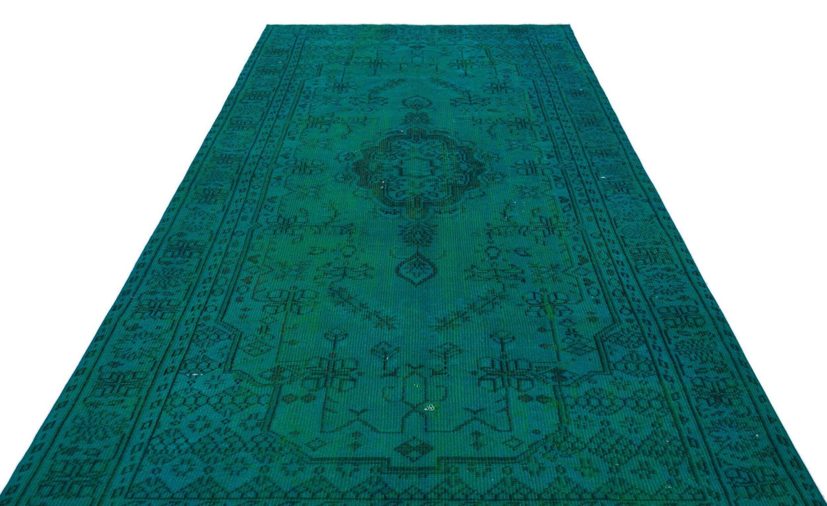 Emerald green runner rug with a dark, distressed traditional medallion pattern and geometric border.