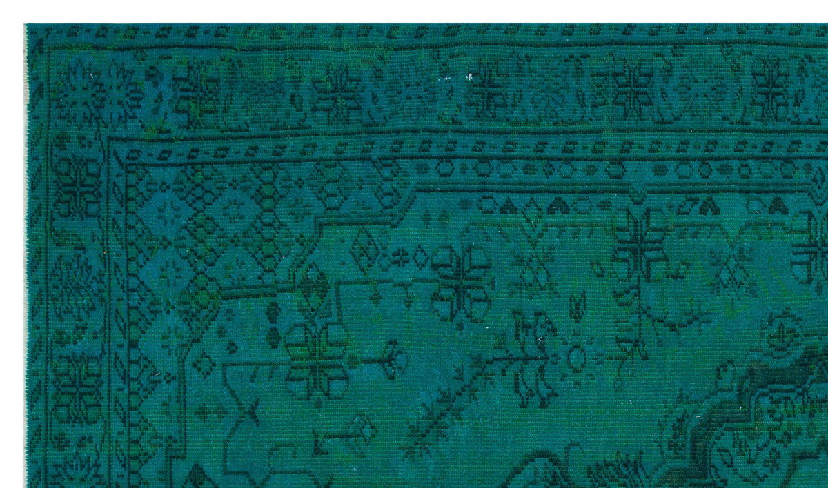 Teal monochromatic rug with a traditional Persian-style floral and geometric border and central medallion pattern.