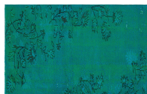 Load image 1 in gallery view. Teal rug with a distressed, dark floral pattern and visible woven texture.