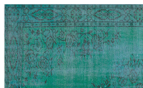 Load image 1 in gallery view. Teal and black distressed rug with a traditional floral border and faded central medallion pattern.