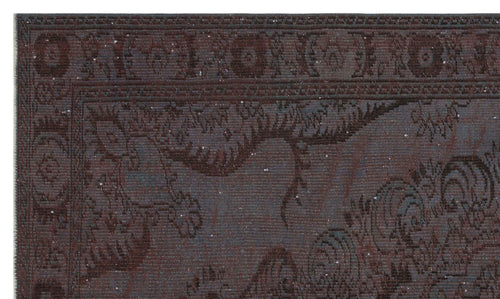 Load image 1 in gallery view. Dark charcoal and brown traditional rug with a distressed, faded floral medallion pattern and a detailed border.