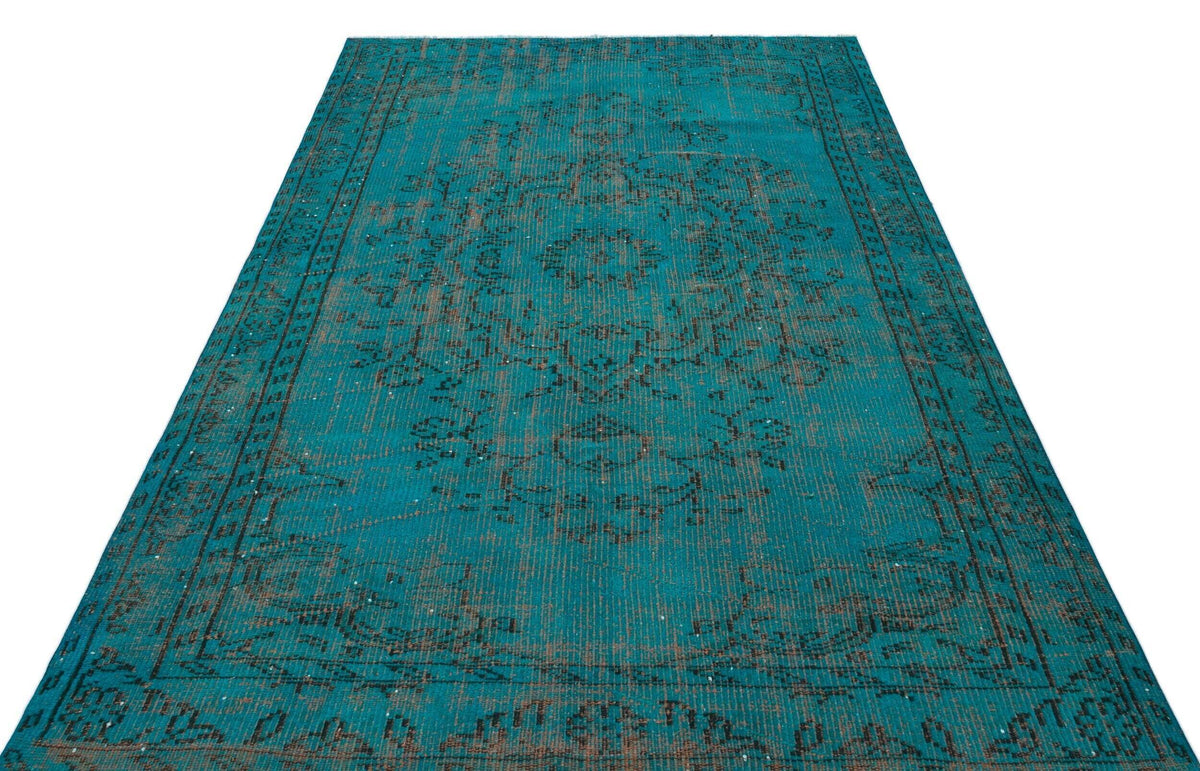 Teal and charcoal distressed rug with a traditional central medallion and ornate border pattern on a white background.