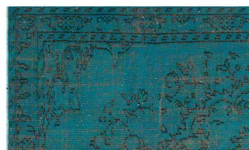 Load image 1 in gallery view. Teal and black distressed rug with a traditional ornate border and floral medallion pattern.