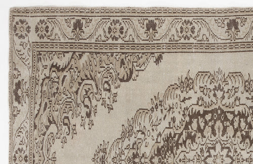 Load image 1 in gallery view. Beige and brown vintage-style rug with a traditional floral medallion pattern and a decorative border.