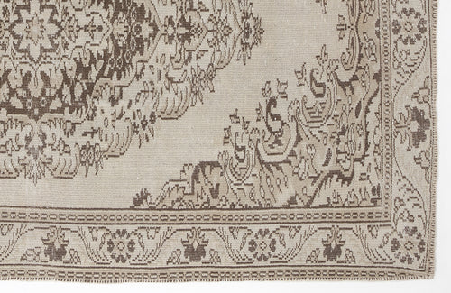 Load image 1 in gallery view. Beige and brown vintage-style rug with a traditional floral medallion pattern and a detailed border.
