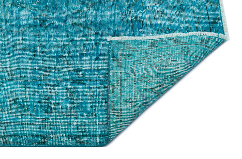 Load image 1 in gallery view. Teal and black distressed traditional rug with a folded corner showing the woven backing on a white background.