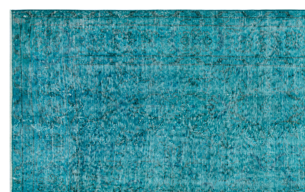 Teal distressed rug with a faded traditional medallion pattern on a white background.